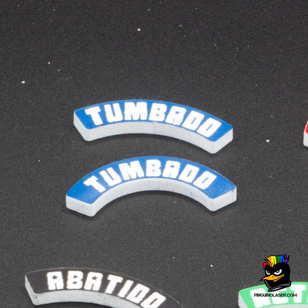 Dos marcadores de metacrilato con el texto "Tumbado" en tipología de Punkapocalyptic. El de arriba es para peanas de 40mm y el de abajo para peanas de 25mm. Son de color azul con las letras en blancas. Se ponen junto a la peana, ya que la forma curvada de los marcadores se ajusta a la circunferencia de la misma.